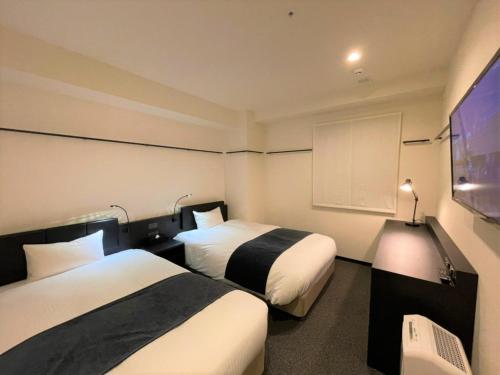 Postel nebo postele na pokoji v ubytování HOTEL SUI KANDA by ABEST