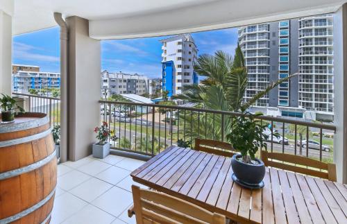 a balcony overlooking a city with a view of the ocean at Paradis Pacifique in Maroochydore