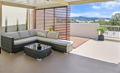 a living room filled with furniture and a window at Paradis Pacifique in Maroochydore