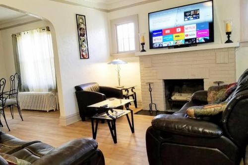 a living room with leather furniture and a flat screen tv at 2 BR Apt near Great Lakes Naval Base and 6 Flags in Waukegan