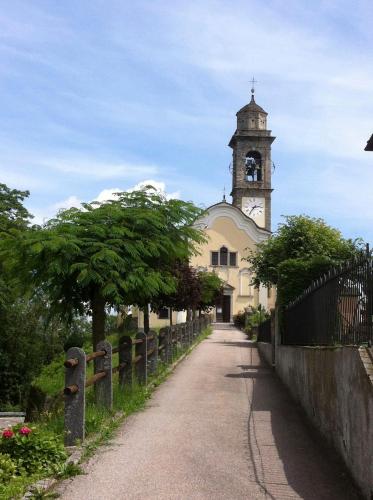 a church with a clock tower in the distance at Ca' di Pincia in Astano