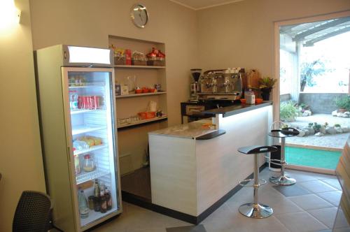 a kitchen with a refrigerator and a counter at Hotel 4 Strade in Ortona