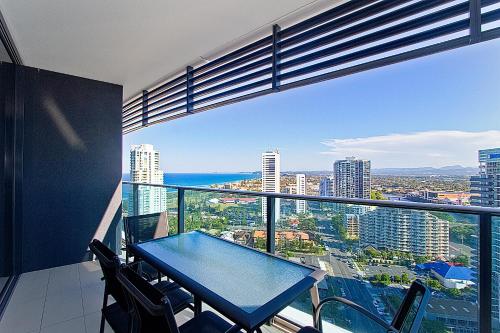 a balcony with a table and chairs in a building at Oracle Resort Broadbeach - gclr in Gold Coast