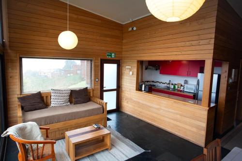 a living room with a couch and a table at Cabañas Tungulú in Puerto Montt