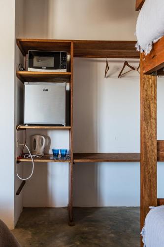 a bedroom with a bunk bed with a microwave on a shelf at Vistazul in Vichayito