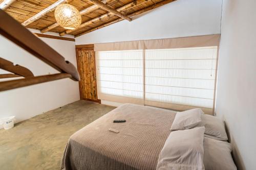 a bedroom with a bed in a room with a window at Vistazul in Vichayito