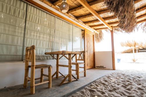 a wooden table and a chair in a room at Vistazul in Vichayito