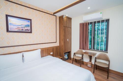 a hotel room with a bed and a window at Khách sạn Hoàng Yến in Lao Cai