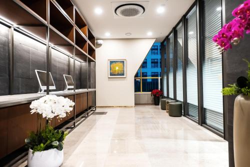 an office corridor with flowers and plants at Intrada Icheon Hotel in Icheon