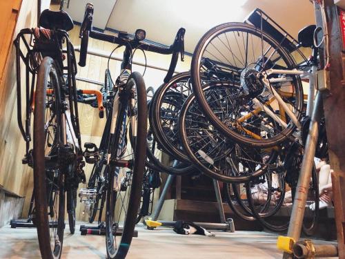 a bunch of bikes on a rack in a room at おとまち 甘藍 Otomachi Kanran in Kure