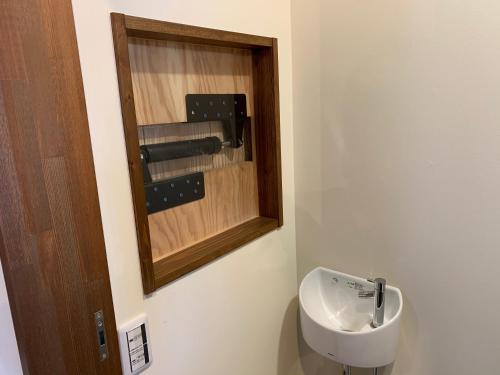 a bathroom with a toilet and a sink at 片原楽家 旅人の長浜町家ドミトリー in Nagahama