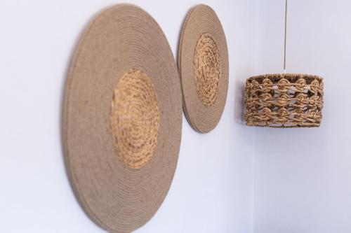 a pair of straw hats hanging on a wall at verykokkos collection suites mikri vigla in Mikri Vigla