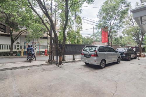 a silver car parked on the side of a street at RedDoorz near Exit Toll Pasteur 4 in Bandung