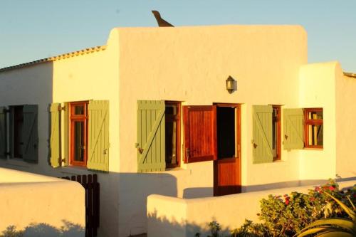 a building with colorful doors and windows on it at C-Breeze in Paternoster