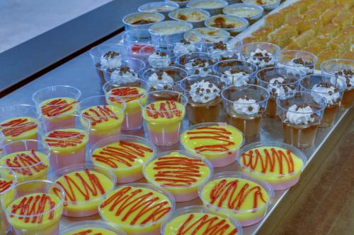 a tray of cups filled with drinks and desserts at Hotel Grand Efe in Ozdere
