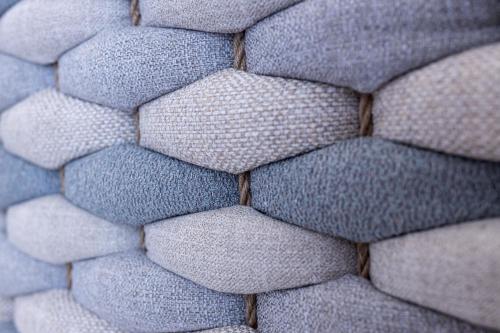 a close up of a close up of a gray couch at verykokkos collection suites mikri vigla in Mikri Vigla