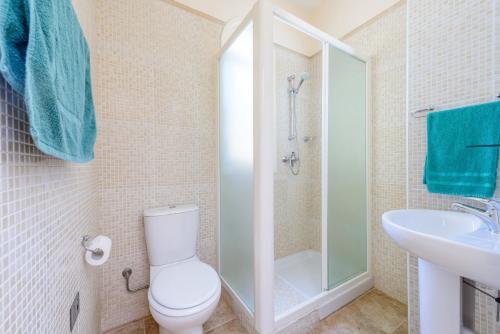 a bathroom with a toilet and a sink at Villa Irina in Paralimni