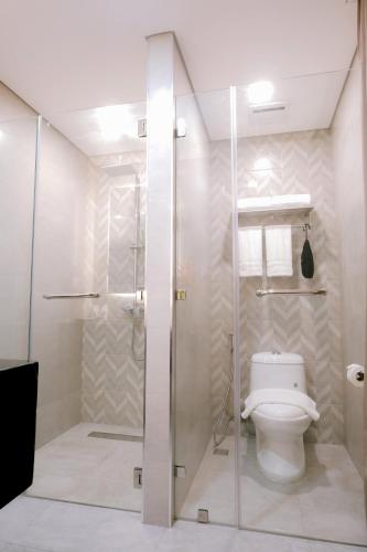 a bathroom with a shower and a toilet at Goldberry Suites and Hotel Cebu in Cebu City