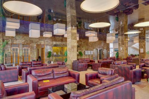 a waiting room with leather chairs and tables at Hotel Grand Efe in Ozdere