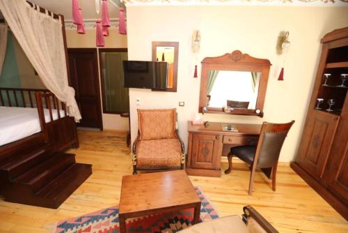 a bedroom with a bed and a desk and a bed and a table at Garden House Hotel - Special Class in Istanbul