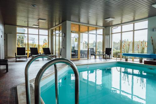 a large swimming pool in a building with a pool at Spa Hotel Ezeri in Sigulda