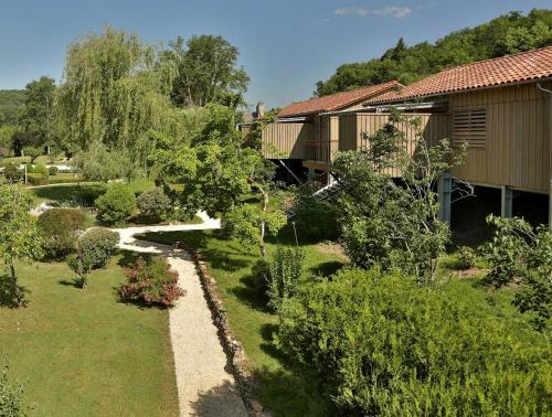 an overhead view of a garden with trees and a house at Les Glycines - Hôtel & Spa - Teritoria in Les Eyzies-de-Tayac