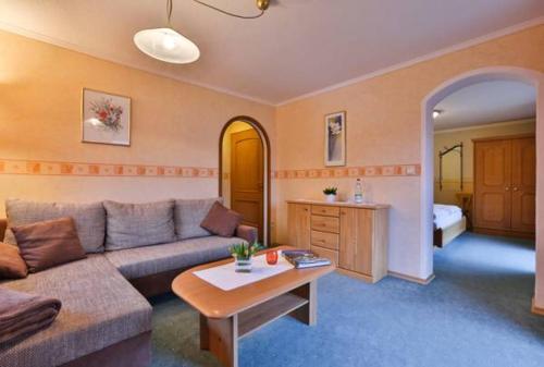ein Wohnzimmer mit einem Sofa und einem Tisch in der Unterkunft Haus Almfrieden in Ramsau bei Berchtesgaden