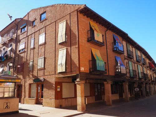 a large brick building with windows on a street at -La Olmeda- La Casona del Zoilo in El Burgo de Osma