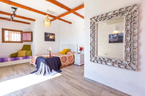 a bedroom with a bed and a large mirror at La Ballena Azul CONIL in Cádiz