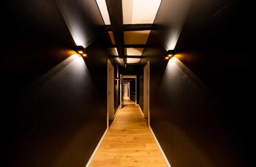 a dark hallway with lights on the walls at Romantik Hotel Walhalla in Osnabrück