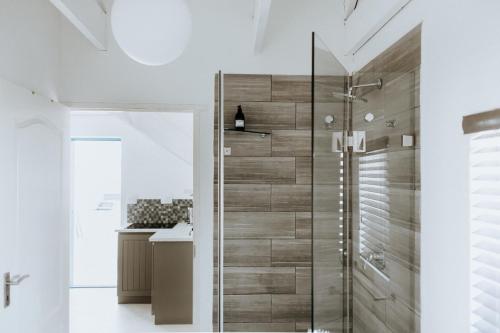 a bathroom with a shower with a glass door at Aloha 1 in Paternoster
