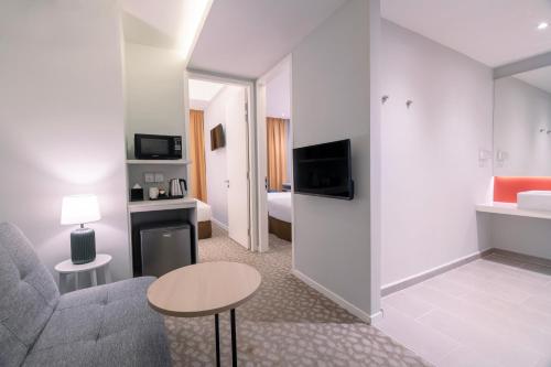 a living room with a couch and a table in a room at Holiday Inn Express & Suites Johor Bahru by IHG in Johor Bahru