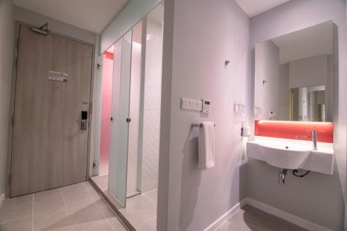 a bathroom with a sink and a shower at Holiday Inn Express & Suites Johor Bahru by IHG in Johor Bahru
