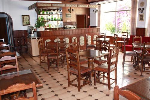 a restaurant with tables and chairs in it at Hotel Dona Leonor in Caldas da Rainha