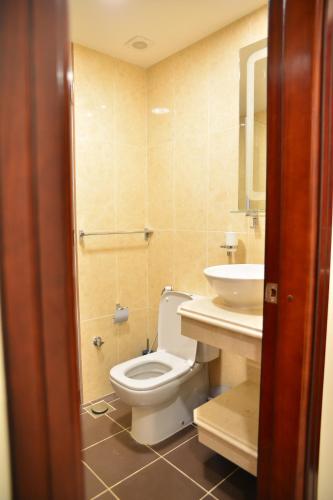 a bathroom with a toilet and a sink at RED SEA HOTEL APARTMENT in Djibouti