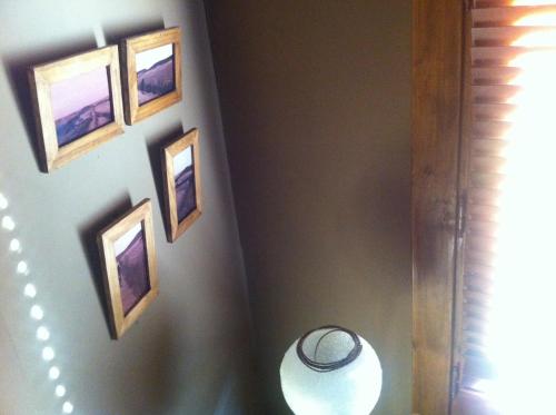 a hallway with four pictures on a wall at Las Horas Perdidas in Manzanares el Real