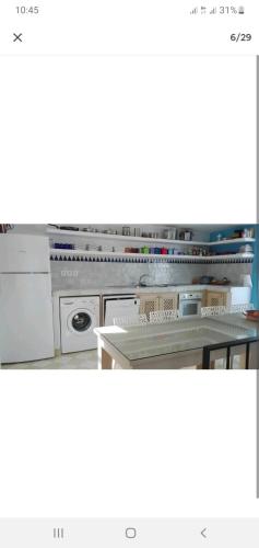 a kitchen with a stove and a dishwasher at Dar 21 in Tangier