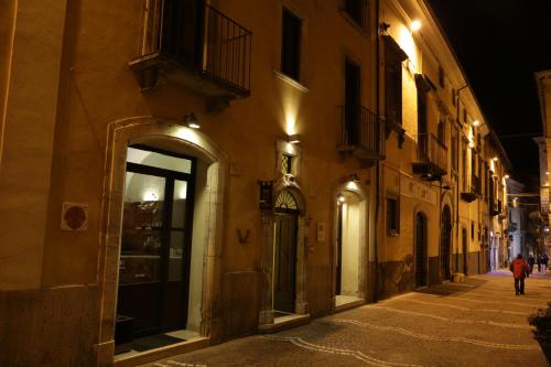 a person walking down a street at night at Stella CasaBono in Sulmona