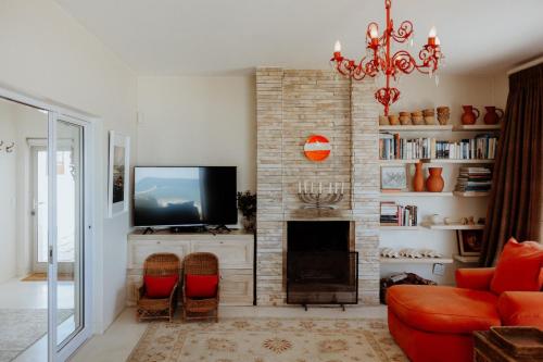 a living room with a tv and a fireplace at As it is in Heaven in Paternoster