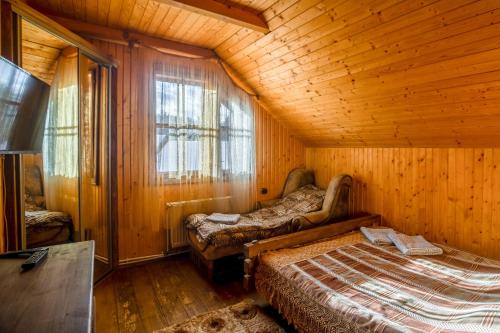 a bedroom with two beds in a wooden room at Skyta in Vorokhta