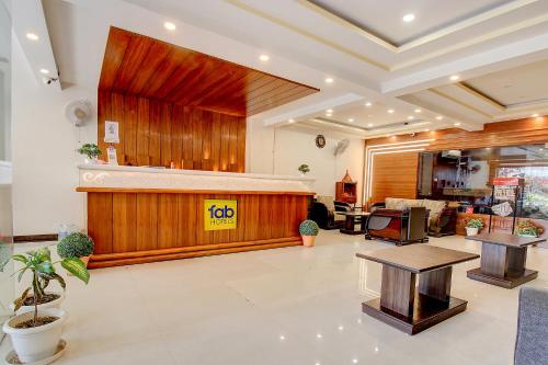 a lobby with a waiting area with a wooden wall at FabHotel PS Grand in Lucknow