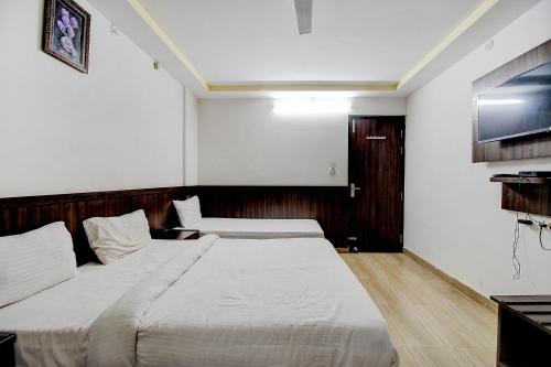 a bedroom with a large white bed in it at FabHotel PS Grand in Lucknow