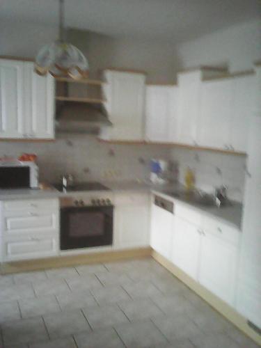 an empty kitchen with white cabinets and appliances at Ferienwohnung Hammerlhaus-Zirngast in Eibiswald