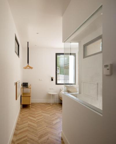 a white room with a hallway with a window at SOLOA LANDETXEA in Bakio