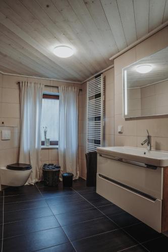 a bathroom with a tub and a sink and a toilet at Hütte54 in Goslar