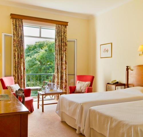 a hotel room with a bed and a window at Quinta da Bela Vista in Funchal