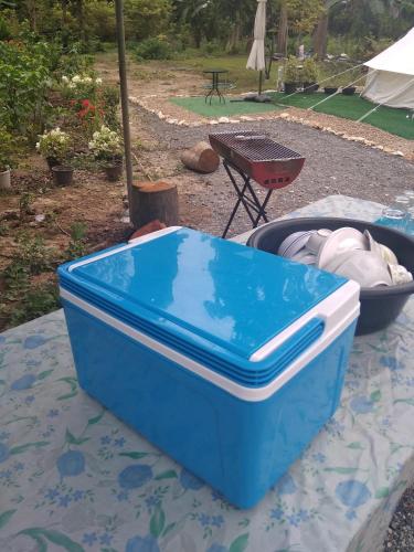 a blue and white cooler sitting on a table at ชายเขาโฮมสเตย์ in Kanchanaburi