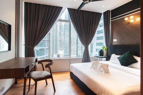 Ένα ή περισσότερα κρεβάτια σε δωμάτιο στο GH KLCC Apartment by GuestHouse