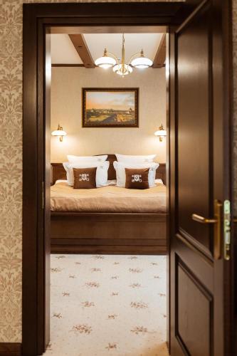 a view of a bedroom with a bed through a door at GasthauS & SPA in Bukovel