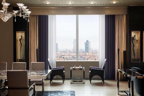 a dining room with a table and chairs and a large window at Hyatt Centric Levent Istanbul in Istanbul